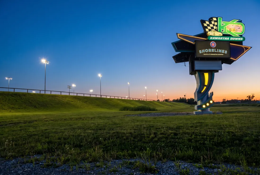 Kawartha Downs sign and track floodlights at dusk